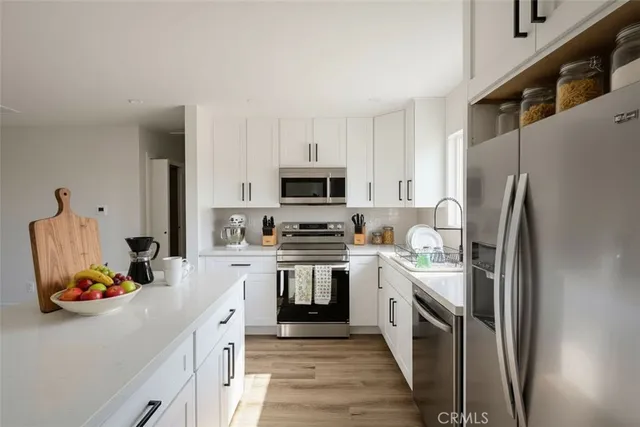 a kitchen with a sink stove and refrigerator