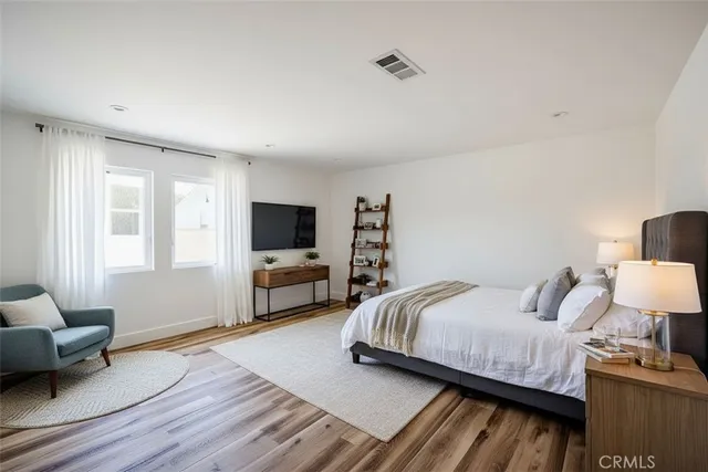 a bedroom with a bed and a couch