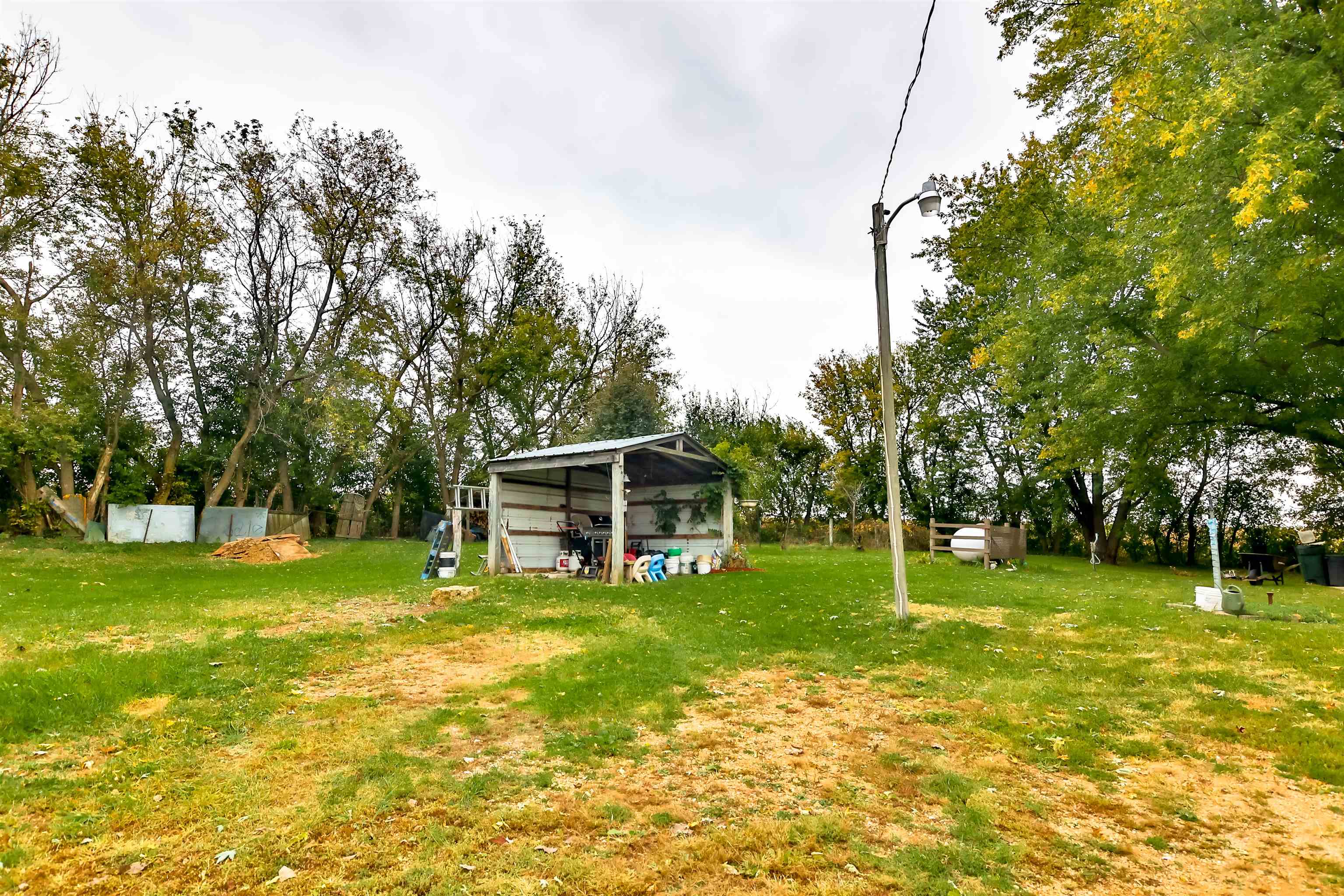 7719 West Coffman Road German Valley, IL 61039 - Photo 12 of 38 a view of a yard with a house in the background