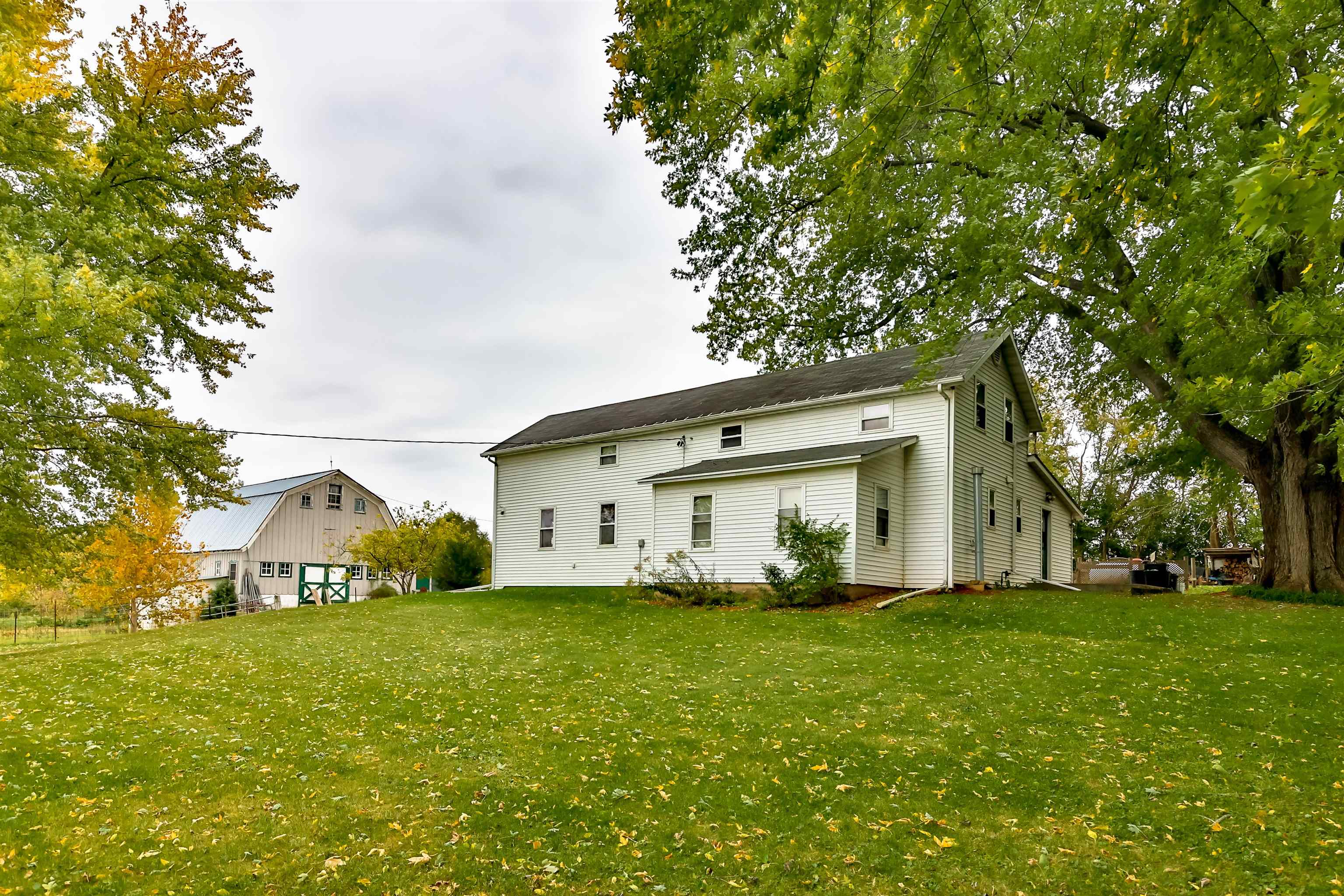 7719 West Coffman Road German Valley, IL 61039 - Photo 13 of 38 a white house with a tree in front of it