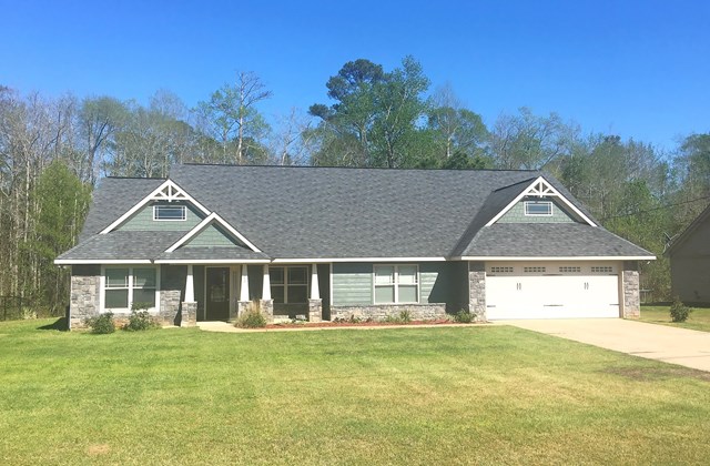 23 Isbell Road Fort Mitchell, AL 36856 - Photo 1 of 37 a front view of a house with a garden and yard
