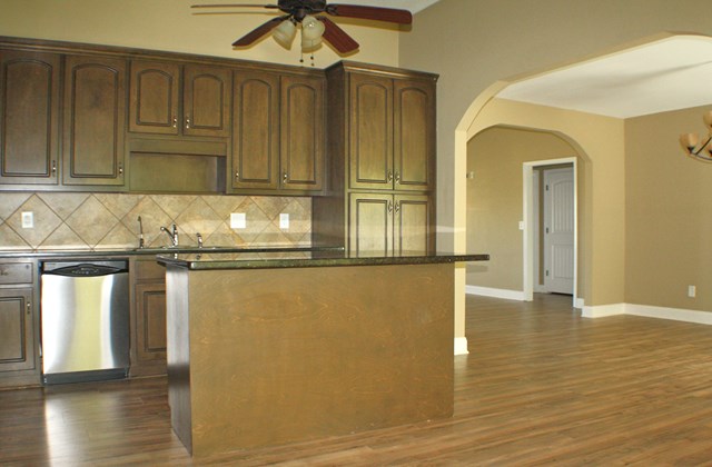23 Isbell Road Fort Mitchell, AL 36856 - Photo 11 of 37 a kitchen with granite countertop a refrigerator and cabinets