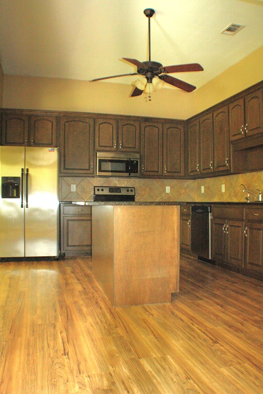 23 Isbell Road Fort Mitchell, AL 36856 - Photo 13 of 37 a kitchen with kitchen island a stove a sink and a refrigerator