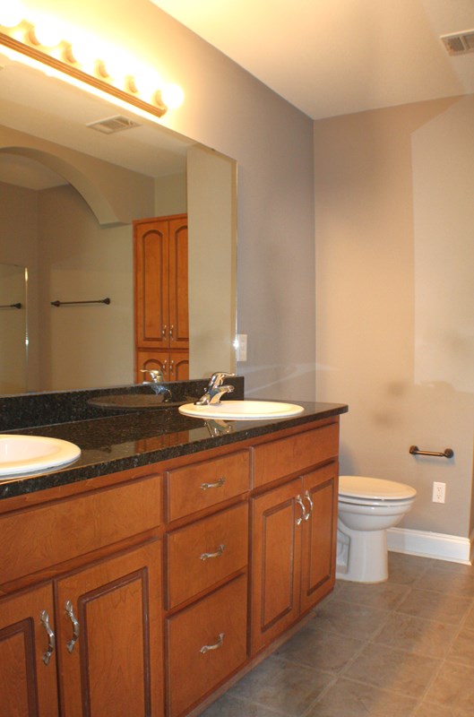 23 Isbell Road Fort Mitchell, AL 36856 - Photo 25 of 37 a bathroom with a granite countertop toilet sink and mirror