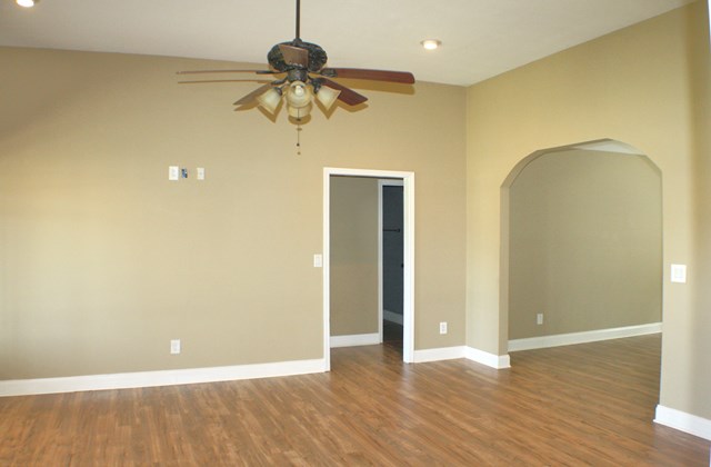 23 Isbell Road Fort Mitchell, AL 36856 - Photo 29 of 37 a view of an empty room with wooden floor and a ceiling fan