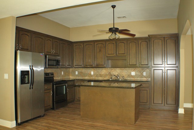 23 Isbell Road Fort Mitchell, AL 36856 - Photo 9 of 37 a kitchen with stainless steel appliances granite countertop a refrigerator a sink and wooden floors