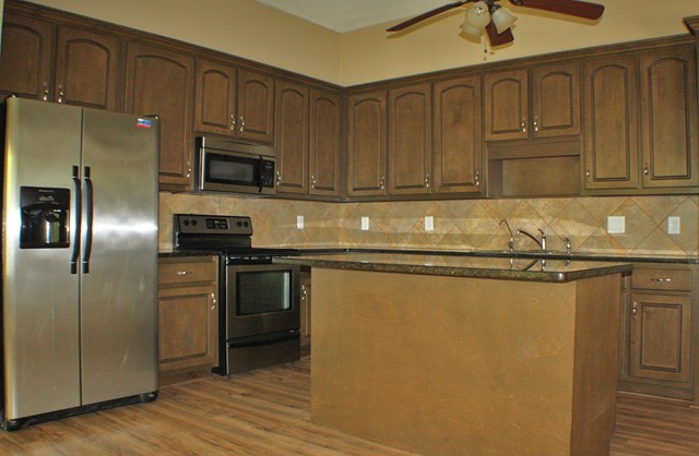 23 Isbell Road Fort Mitchell, AL 36856 - Photo 10 of 37 a kitchen with stainless steel appliances granite countertop a refrigerator a stove and a sink