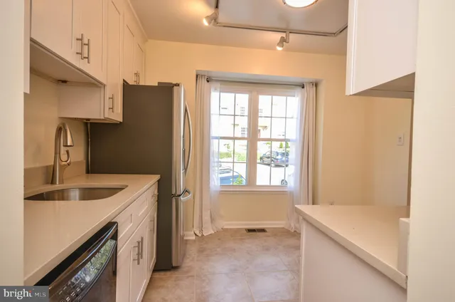 a kitchen with a sink a stove and refrigerator