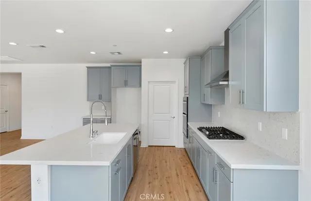 a kitchen with a sink stove and cabinets