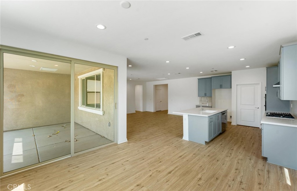 26615 Silver Ore Road Menifee, CA 92570 - Photo 14 of 30 a view of kitchen with granite countertop cabinets and wooden floor