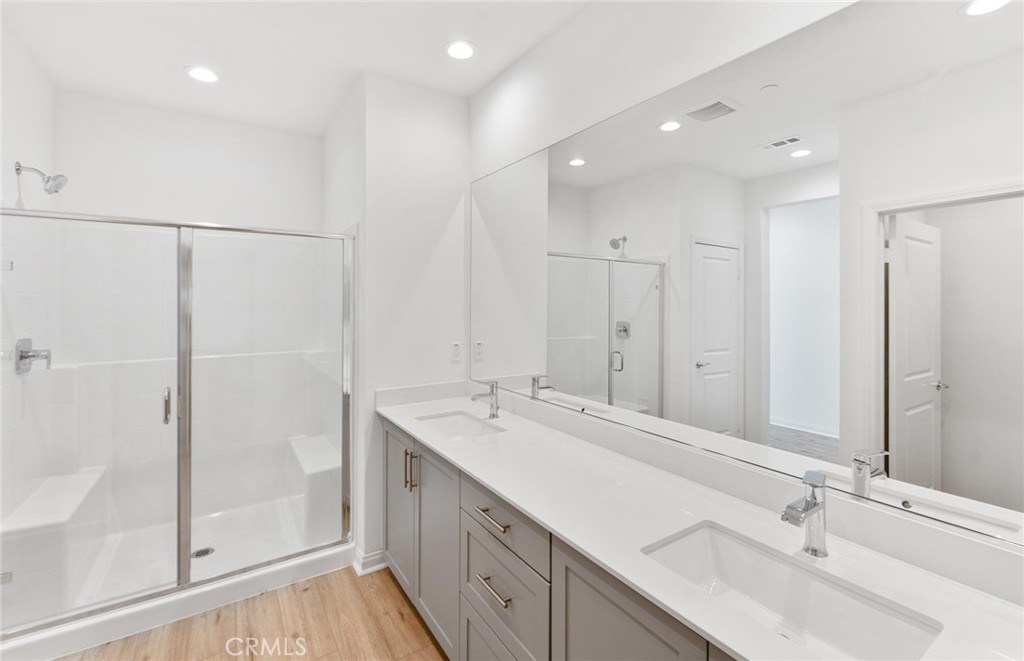 26615 Silver Ore Road Menifee, CA 92570 - Photo 19 of 30 a bathroom with a double vanity sink mirror and shower