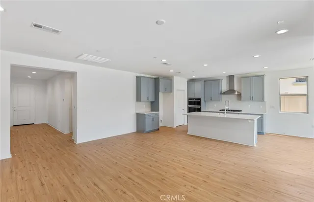 a view of kitchen with kitchen island sink and center island