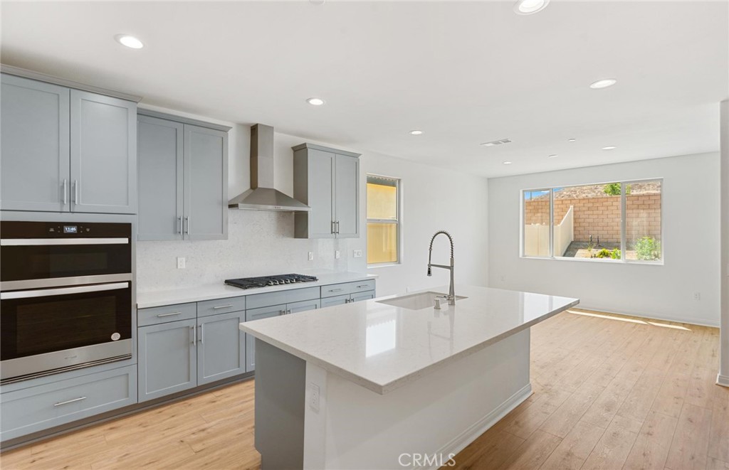 26615 Silver Ore Road Menifee, CA 92570 - Photo 6 of 30 a kitchen with stainless steel appliances granite countertop a sink stove and refrigerator