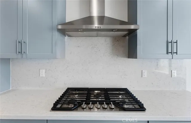 a stove top oven sitting inside of a kitchen