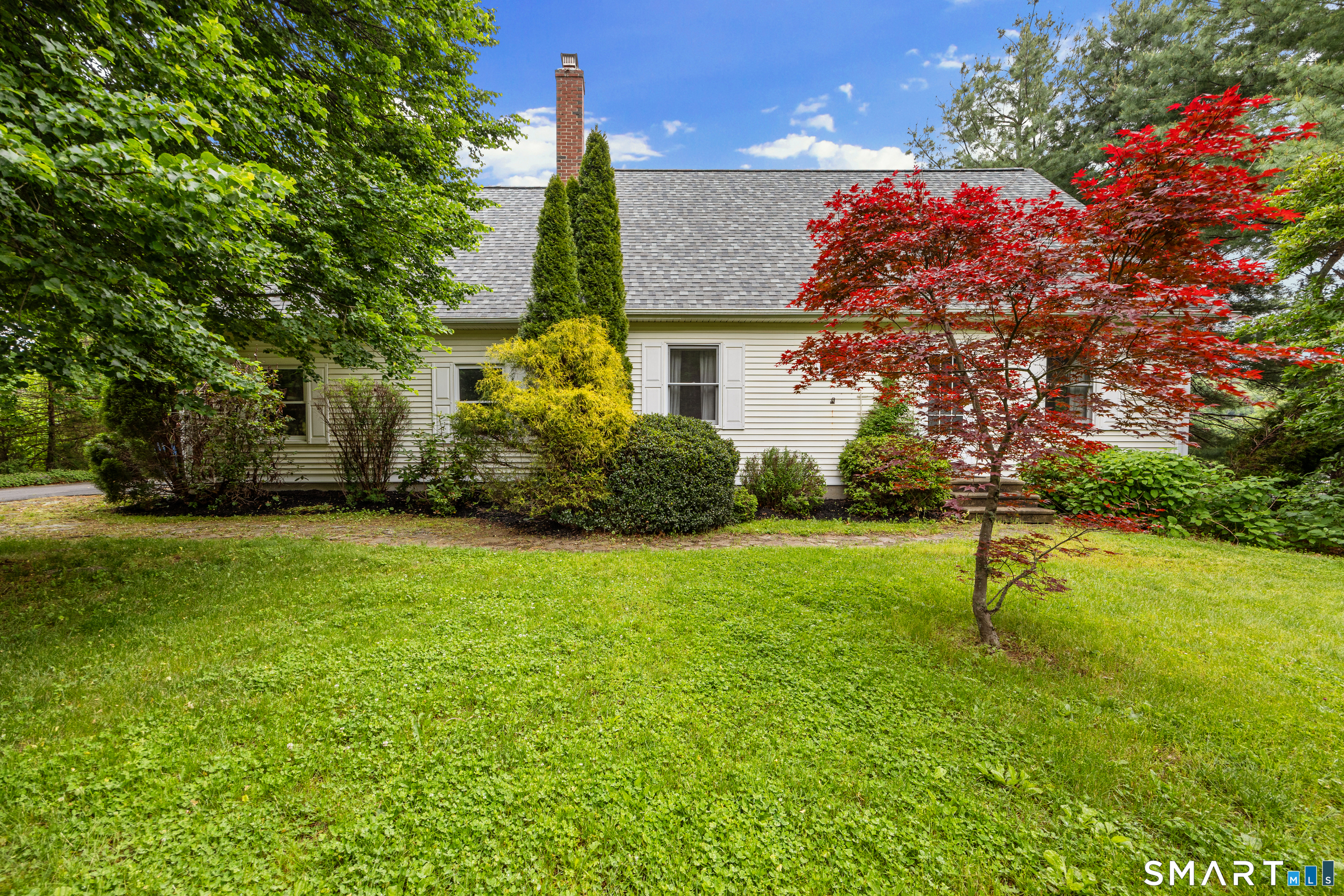 694 Millbrook Road Middletown, CT 06457 - Photo 2 of 34 a garden with trees in front of it