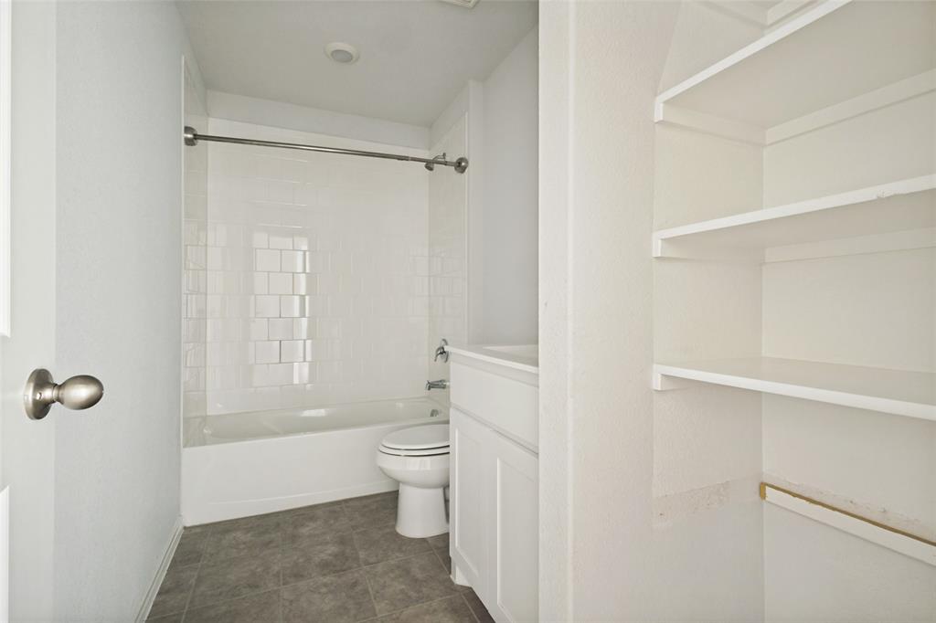 621 Spaulding Street Justin, TX 76247 - Photo 15 of 22 a bathroom with a toilet a sink and shower