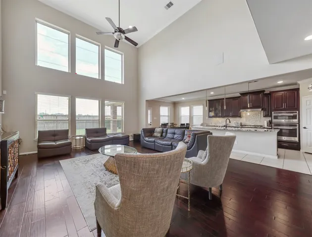 a living room with furniture and a wooden floor