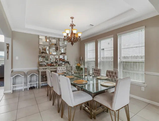 a very nice looking dining room with furniture window and outside view