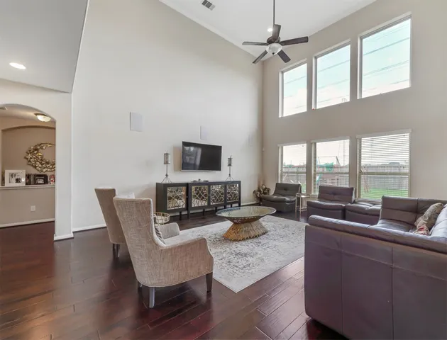 a living room with furniture and a chandelier