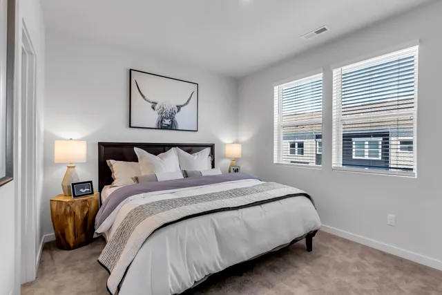 a bedroom with a bed and a painting on the wall