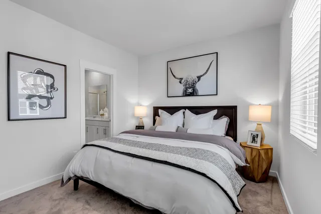 a bedroom with a bed and a painting on the wall