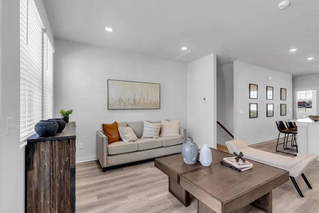 a living room with furniture and wooden floor