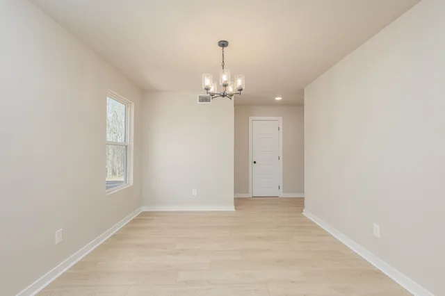 a view of a chandelier in big room and windows