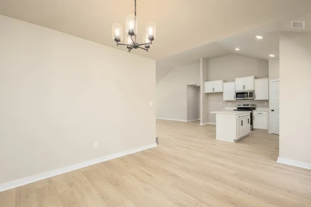 a view of a kitchen with a sink and a refrigerator