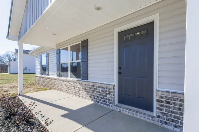 a view of a house with a backyard
