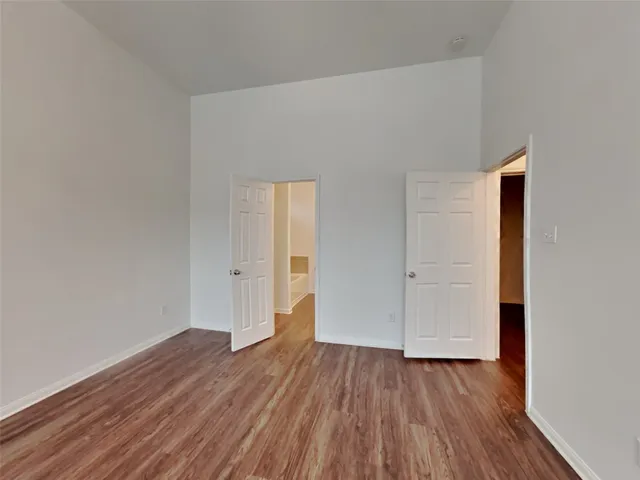 a view of a room with wooden floor