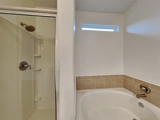 a bathroom with a tub and a shower