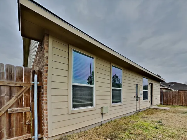 a view of a house with wooden fence