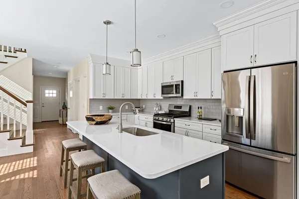 a kitchen with refrigerator cabinets and wooden floor
