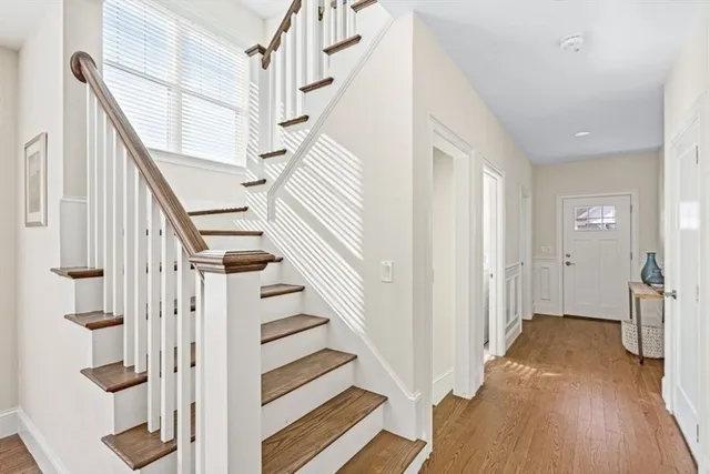 a view of entryway with wooden floor and stairs