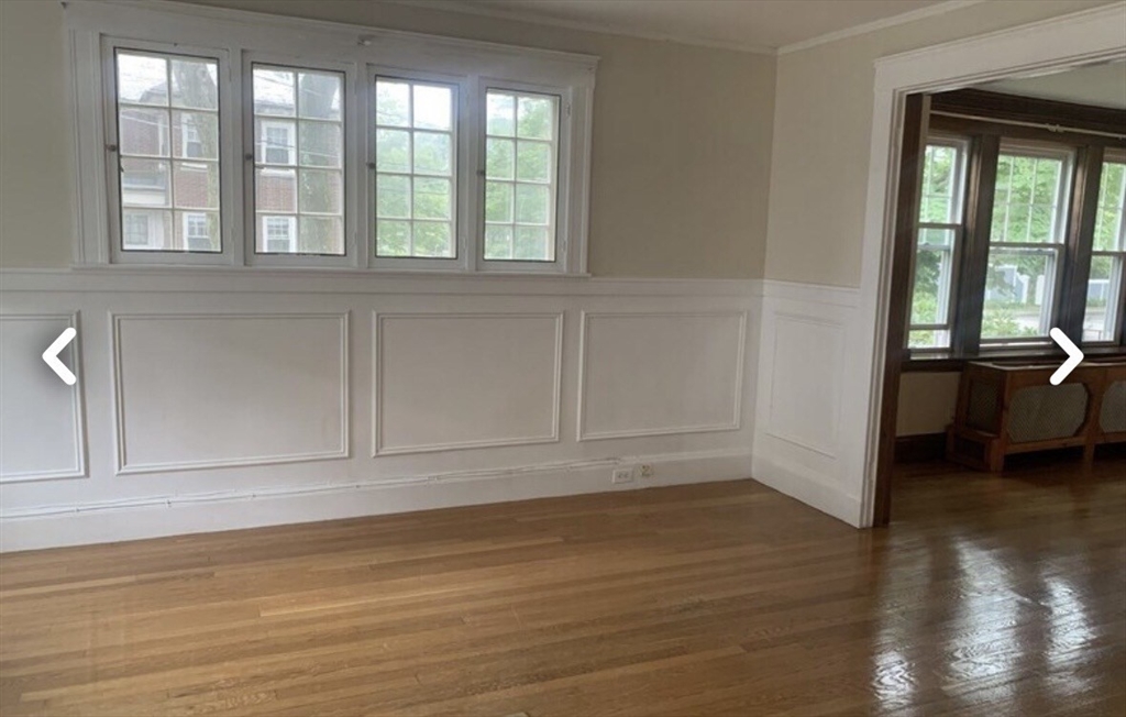 55 Elgin Street, Unit 55 Newton, MA 02459 - Photo 3 of 8 wooden floor in an empty room with a window