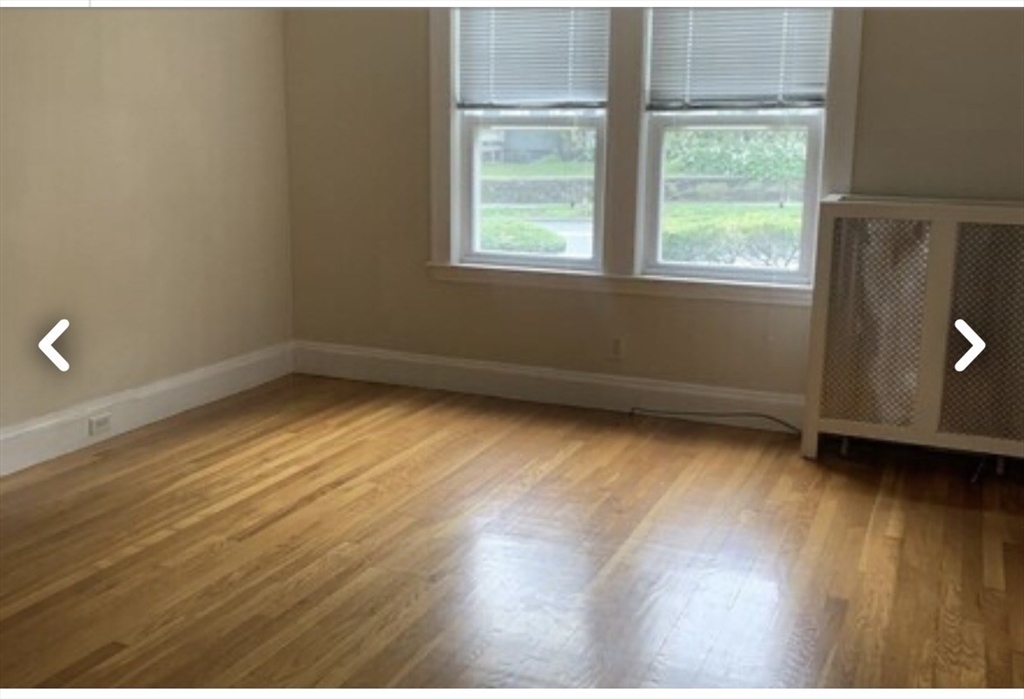 55 Elgin Street, Unit 55 Newton, MA 02459 - Photo 7 of 8 an empty room with wooden floor and windows