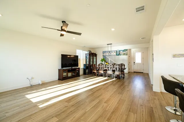 a spacious bedroom with a bed and ceiling fan