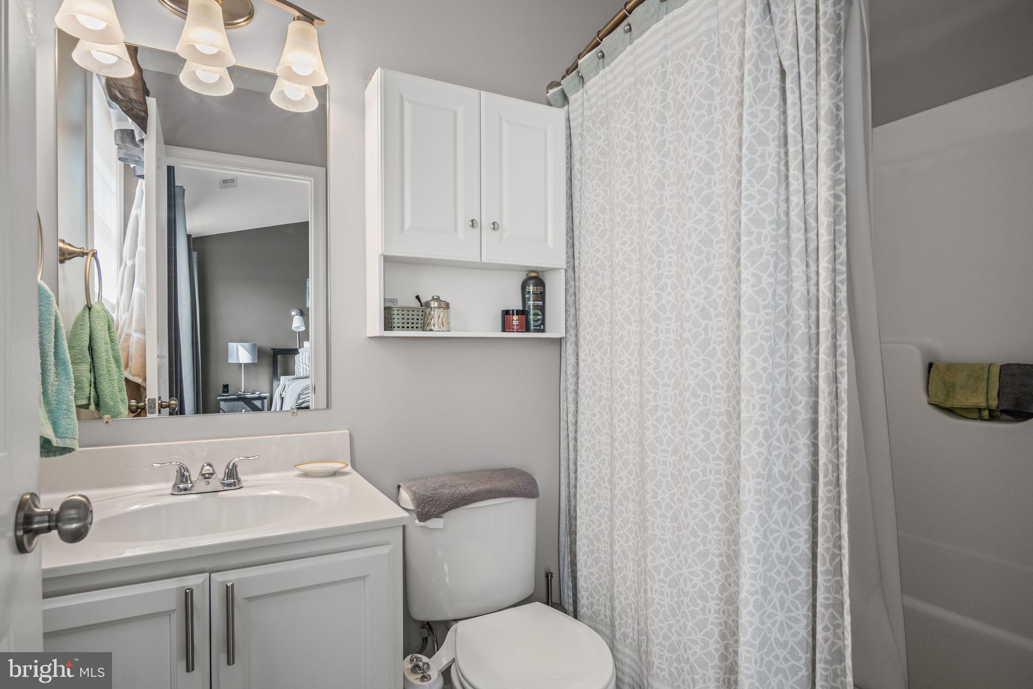 34 Brookside Avenue Hanover, PA 17331 - Photo 30 of 39 a bathroom with a toilet sink vanity and mirror