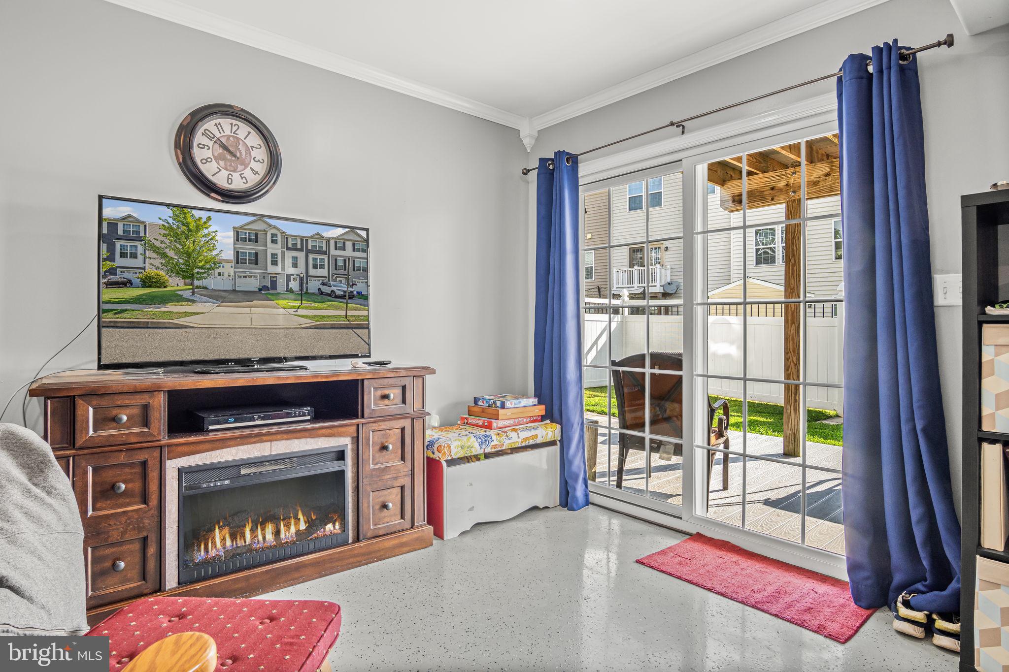 34 Brookside Avenue Hanover, PA 17331 - Photo 8 of 39 a living room with a stove a flat screen tv and a fireplace
