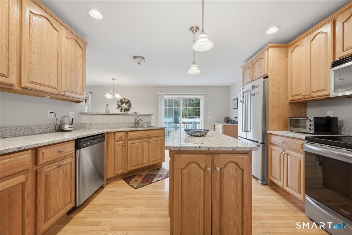 3 Lucienne Way Ledyard, CT 06339 - Photo 13 of 25 a kitchen with stainless steel appliances granite countertop a sink a stove and a refrigerator