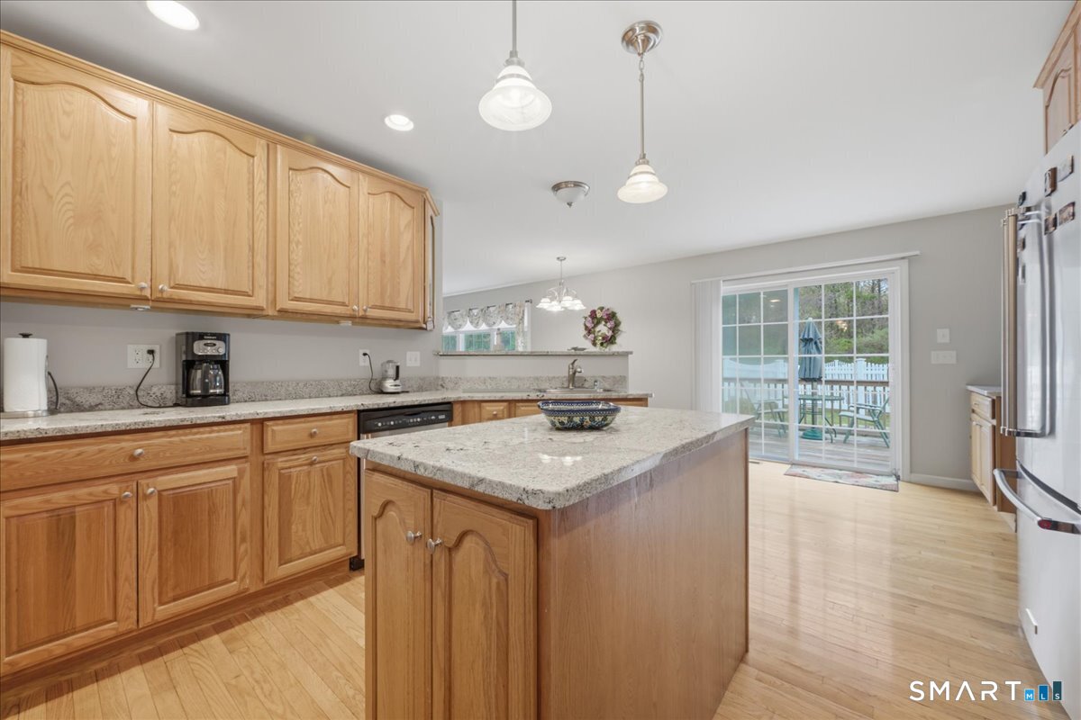 3 Lucienne Way Ledyard, CT 06339 - Photo 14 of 25 a kitchen with stainless steel appliances granite countertop a sink a stove and a wooden floors