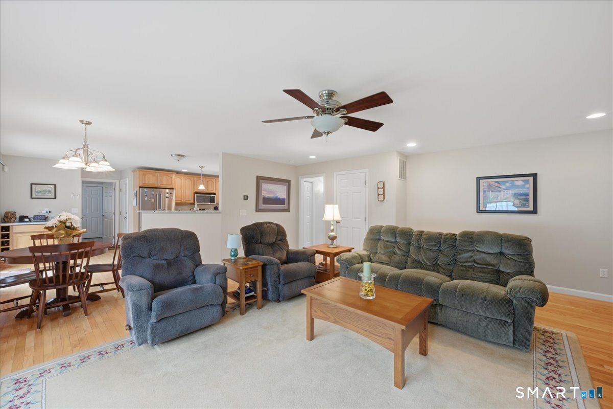3 Lucienne Way Ledyard, CT 06339 - Photo 17 of 25 a living room with furniture a couch and a chandelier