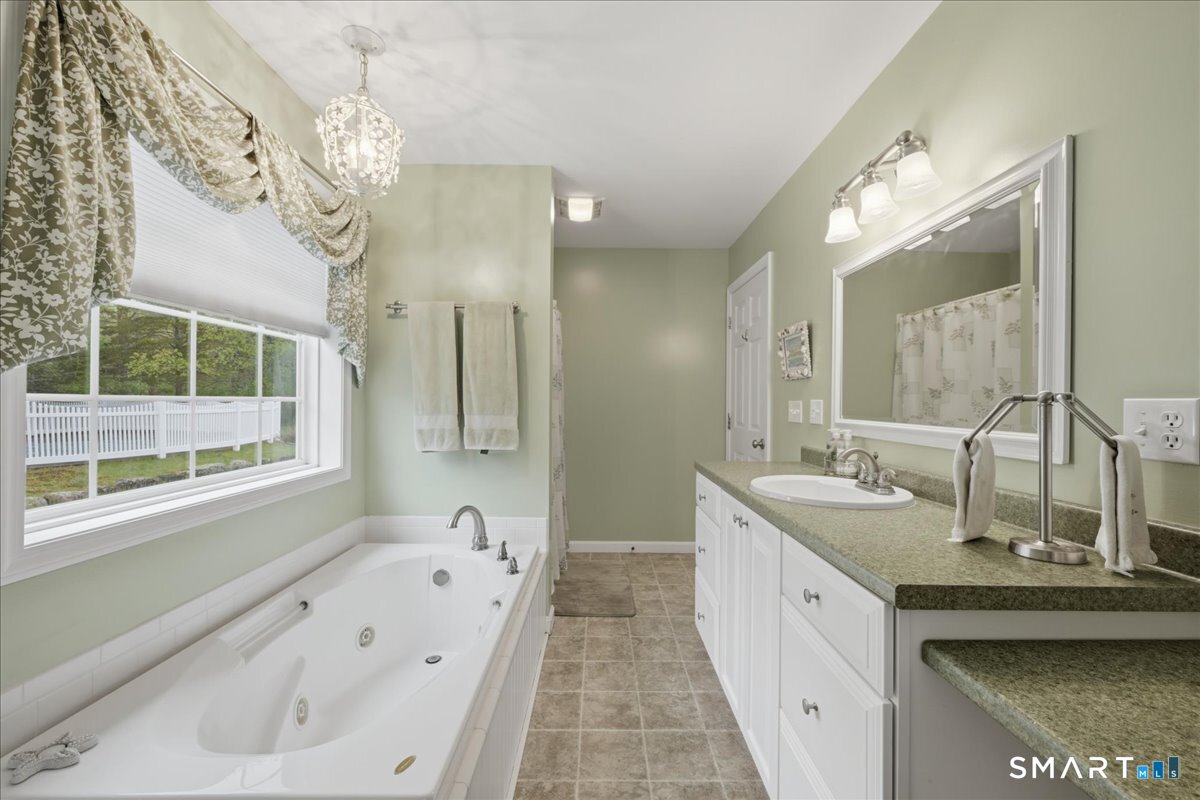 3 Lucienne Way Ledyard, CT 06339 - Photo 19 of 25 a spacious bathroom with a tub sink and mirror