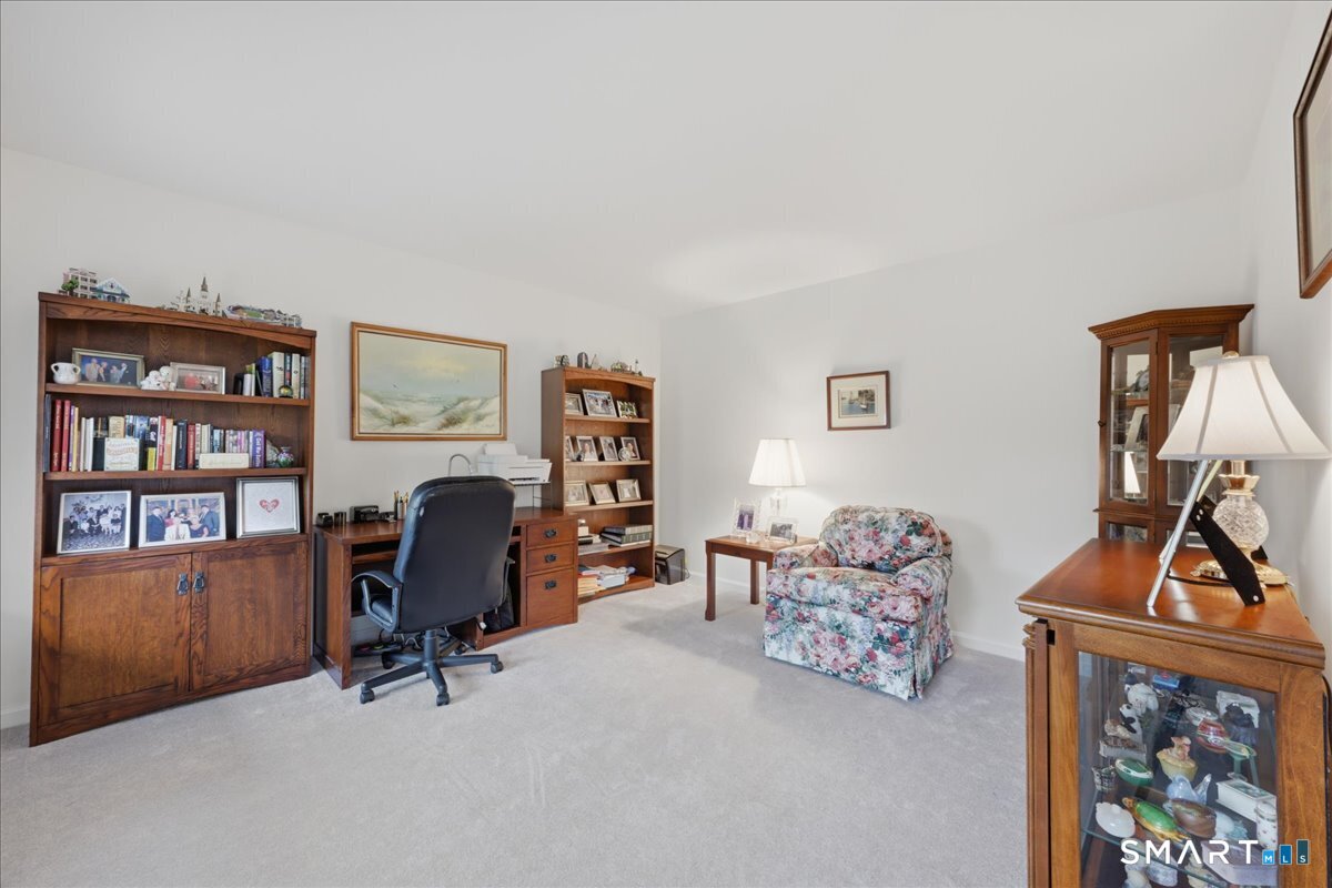 3 Lucienne Way Ledyard, CT 06339 - Photo 21 of 25 a view of a workspace with lounge chair and a bookshelf