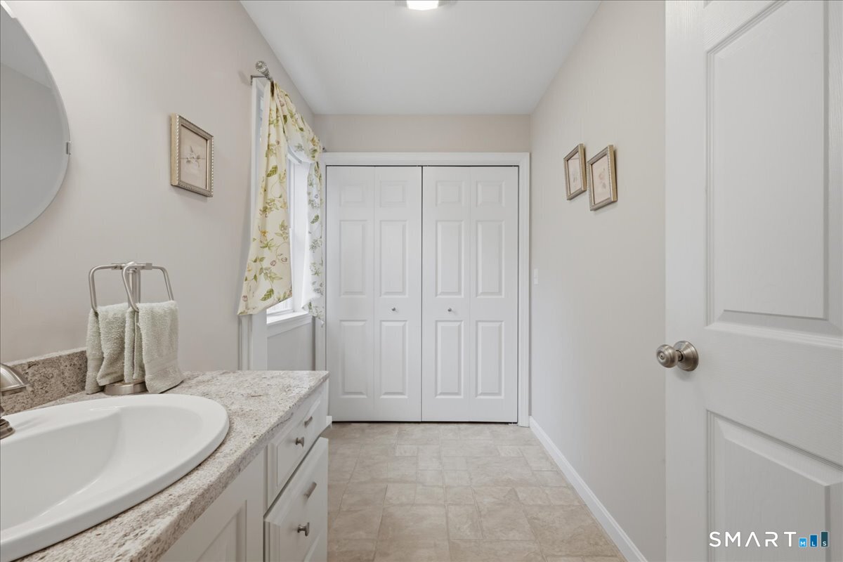 3 Lucienne Way Ledyard, CT 06339 - Photo 22 of 25 a bathroom with a granite countertop sink and a mirror
