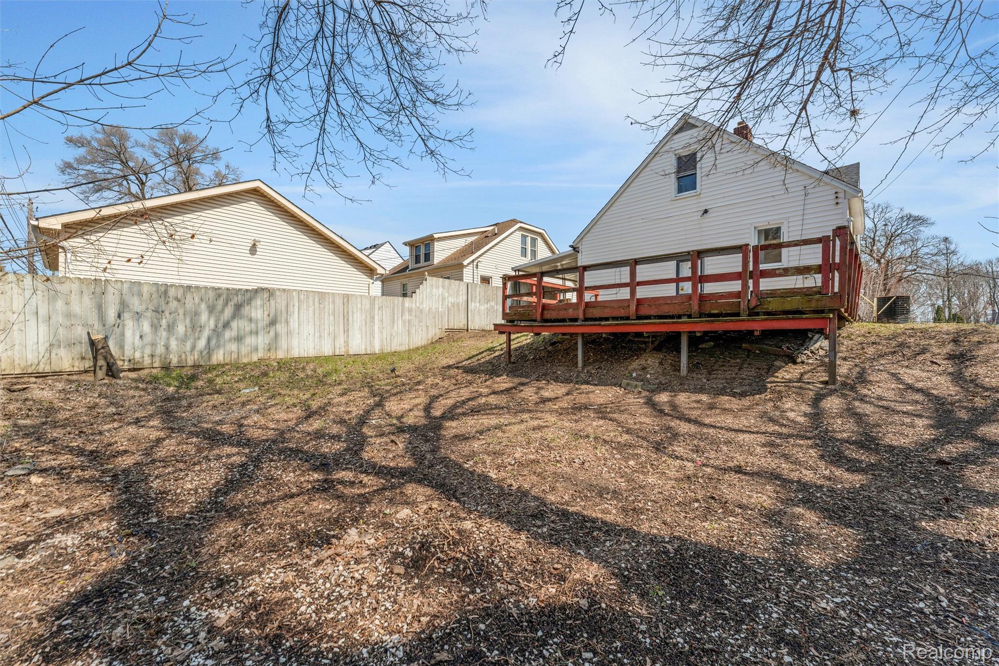 917 Perry Street Pontiac, MI 48340 - Photo 36 of 37 Rear view of property featuring a wooden deck and a chimney