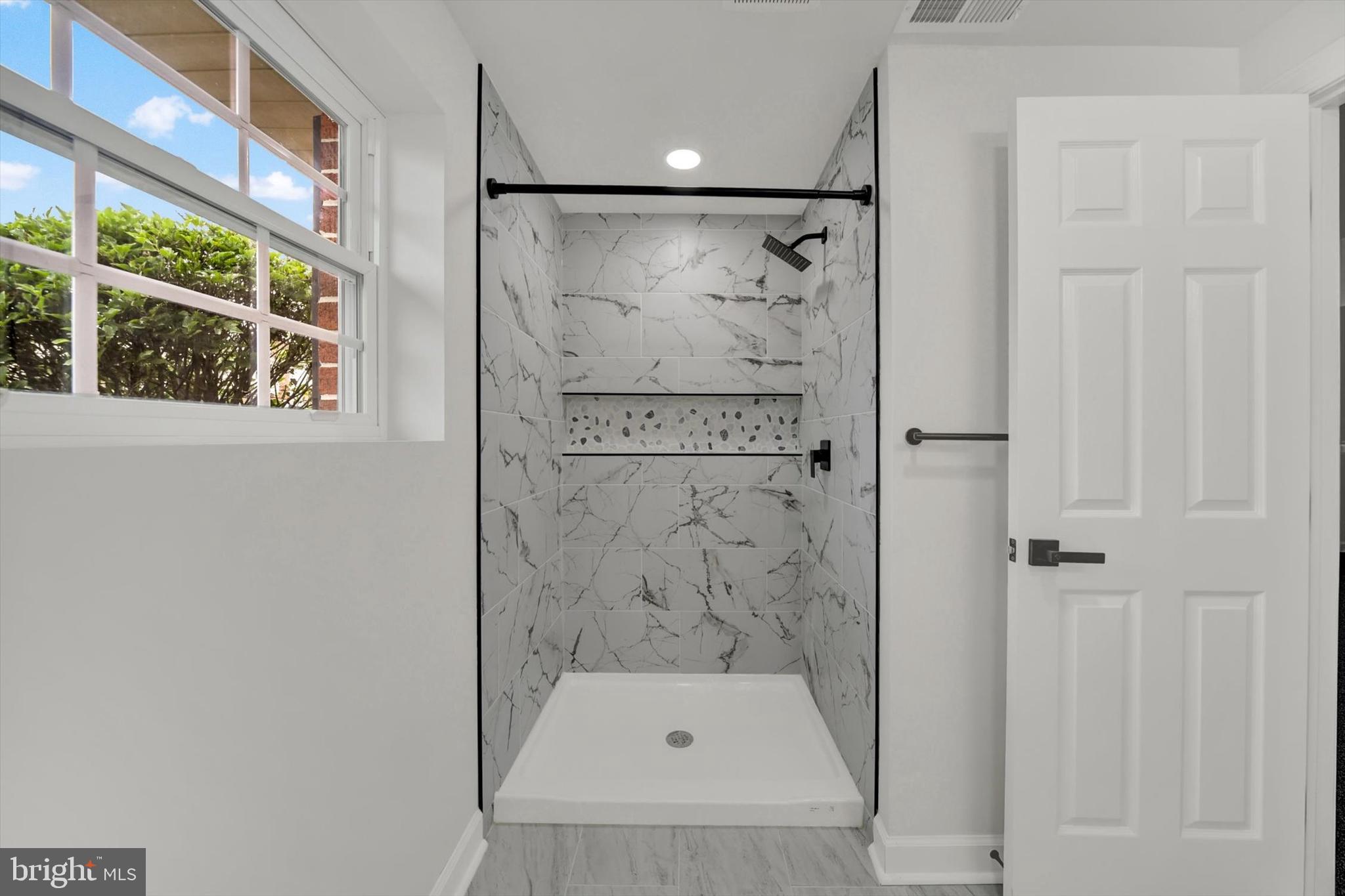 3808 Perryhurst Place Baltimore, MD 21236 - Photo 22 of 29 a bathroom with a shower and mirror