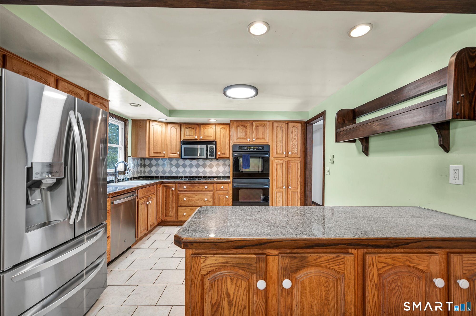 147 Tuttle Road Durham, CT 06422 - Photo 15 of 38 a kitchen with stainless steel appliances granite countertop a lot of counter space and a refrigerator