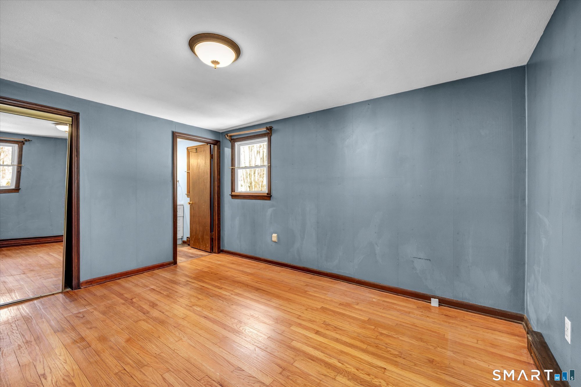 147 Tuttle Road Durham, CT 06422 - Photo 20 of 38 a view of an empty room with wooden floor and a window