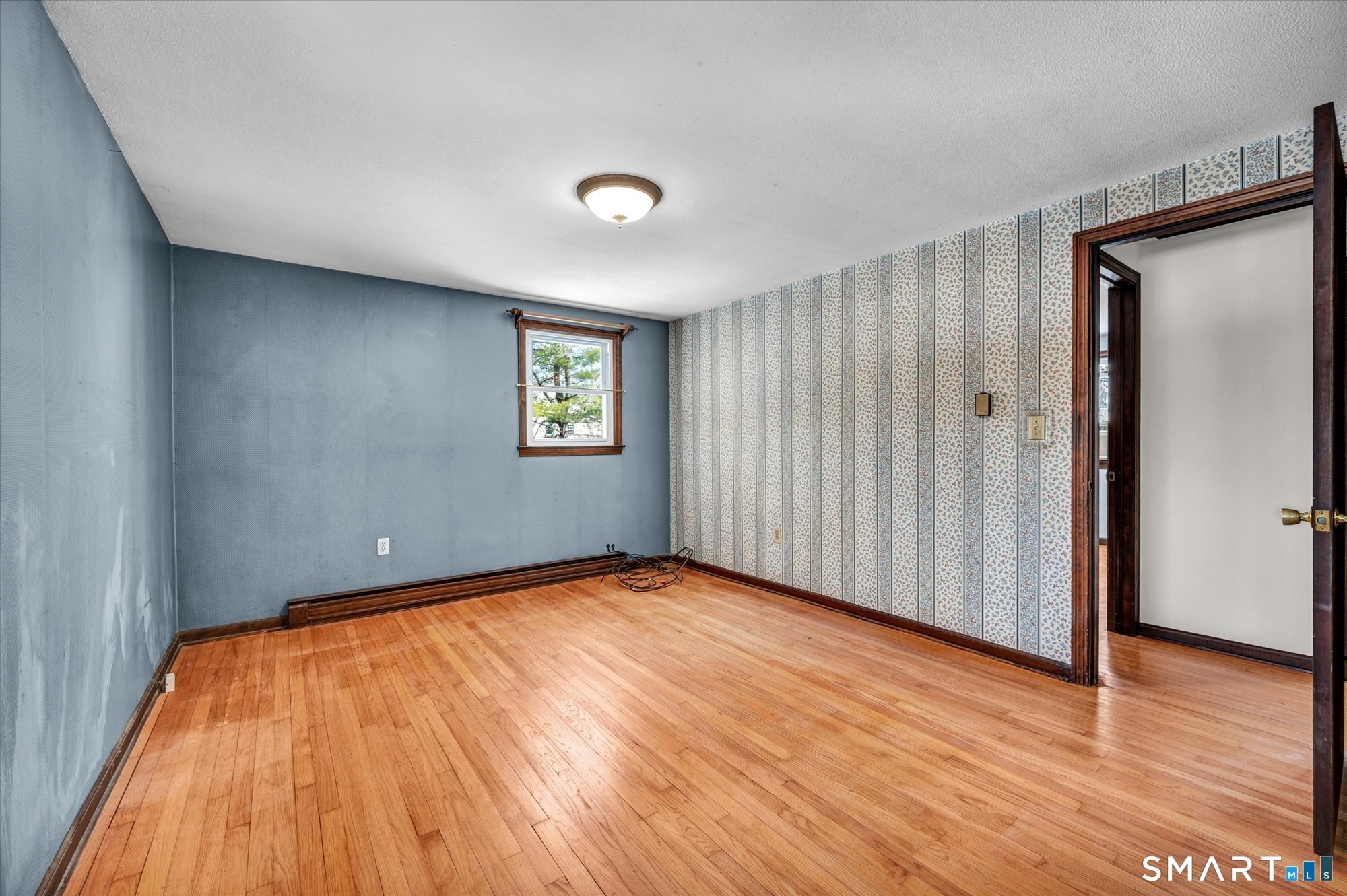 147 Tuttle Road Durham, CT 06422 - Photo 21 of 38 a view of an empty room with wooden floor and a window